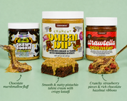 Three jars of Chocbox snack products arranged on a pale green background: a jar of Chewy Cookie Dip on the left with a marshmallow-fluff dip and a spoonful, a jar of Crunchy Dubai Dip in the center with a brownie, and a jar of Crunchy Strawbella Dip on the right with a strawberry hazelnut dip and a spoonful.